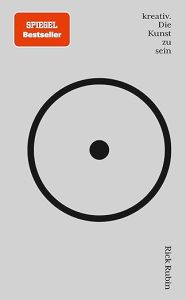 Das Cover ist grau und zeigt einen großen schwarzen Kreis mit einem schwarzen Punkt in der Mitte.